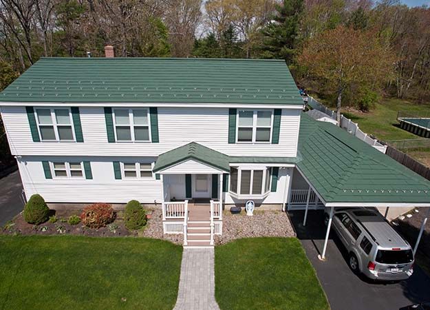 Two-story home with a new green roof installed by Cherry Roofing – showcasing affordable roofing in Vancouver, WA for homeowners seeking financing options.