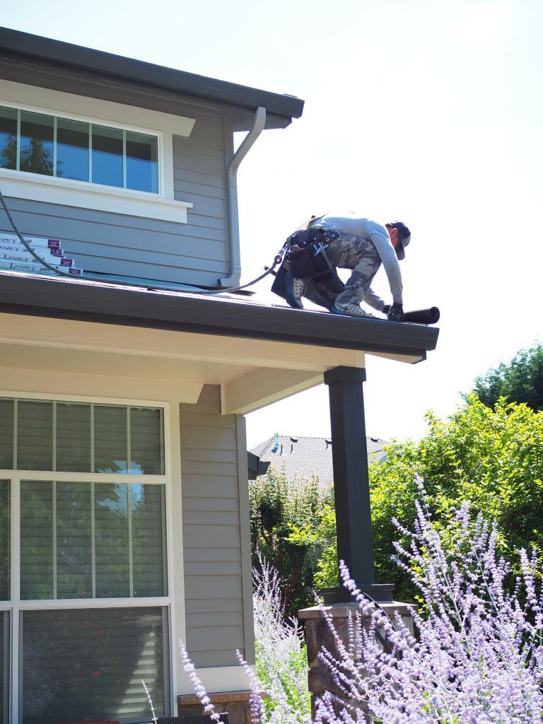 Crew member working on gutter