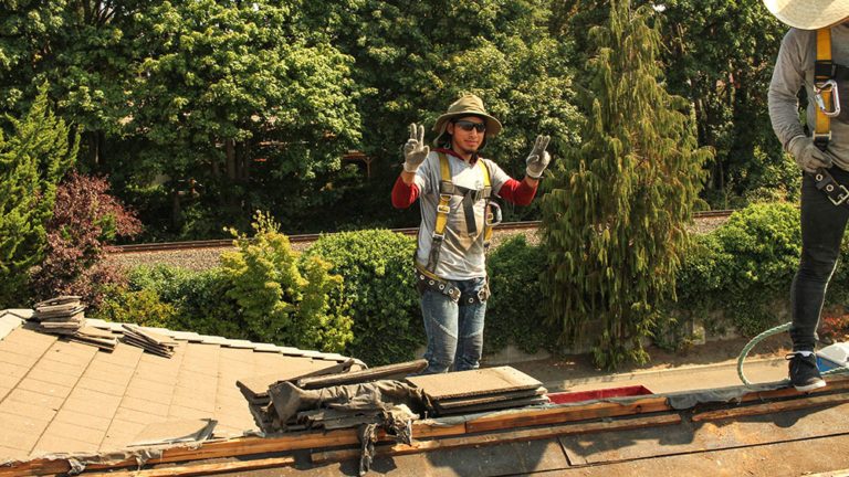 Cherry Roofing crew members hard at work on the roof of a home.